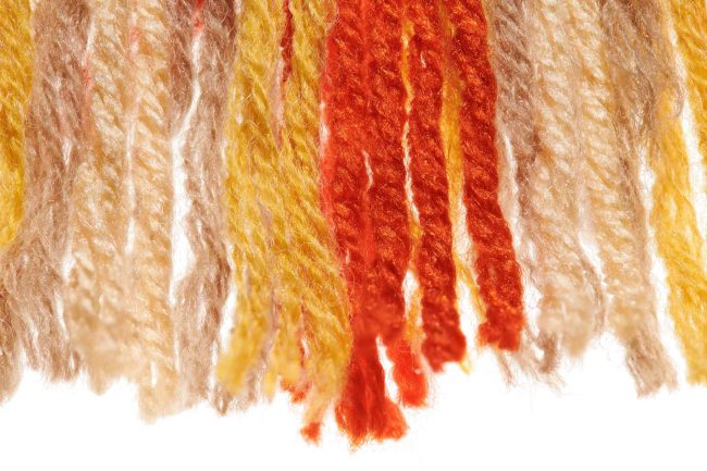 Fringed edges of handmade wool rugs